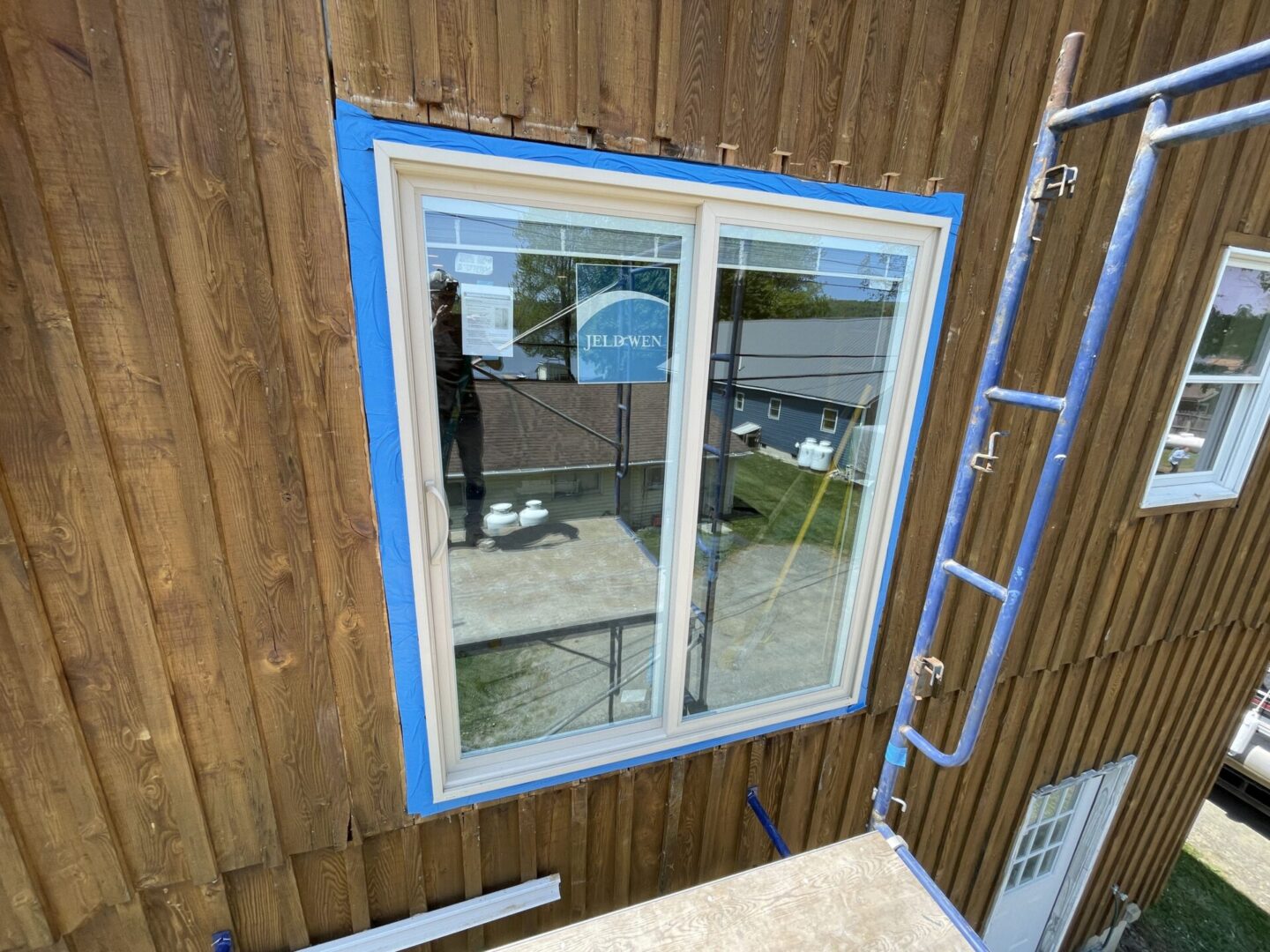 A window being painted in the process of being installed.