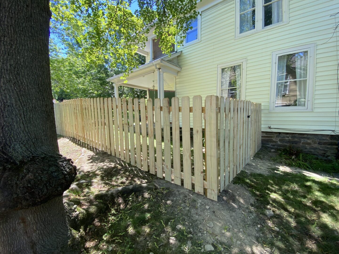 A wooden fence in front of a house.