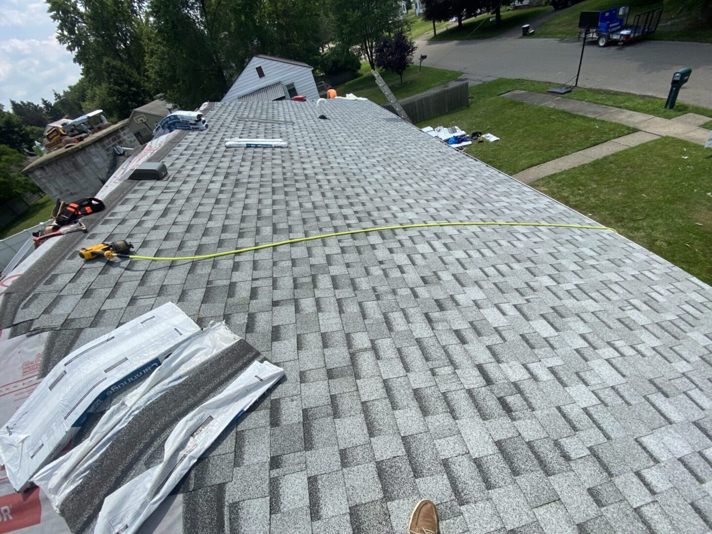 A roof being installed with tape and nails.